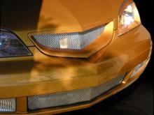 latest grille.  Note how the top section has been molded into a point that reflects the line on the hood.