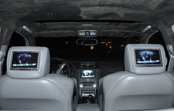 In this pic you can see the two Alpine TME-M780 headrest monitors, the NAVI screen is also tied into the feed thanks to NAVtool. Myron &amp; Davis AD212 DVD player in the dash. Black suede headliner and pillars sets off the whole interior.