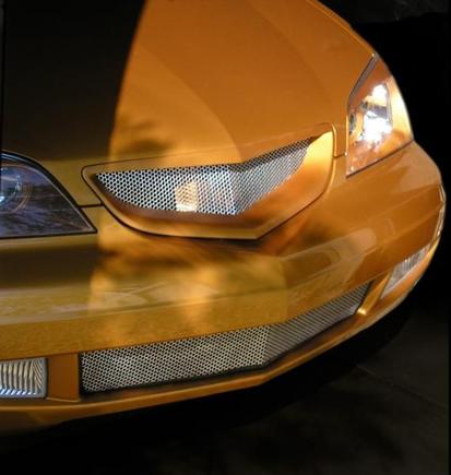 latest grille.  Note how the top section has been molded into a point that reflects the line on the hood.