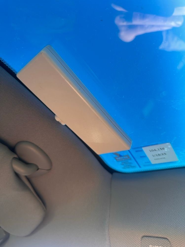 from inside the car. Above drivers seat on top of the windshield. 