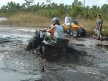 Zane and I digging into a little deeper Mud...  The Girls were fishing out crawdads from the wash my bike made. :-)