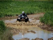 Going thru a deep rutted mud hole up to the tail lights. 

---Thats me!---
