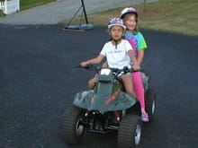Grand daughter driving her quad with her freind on the back