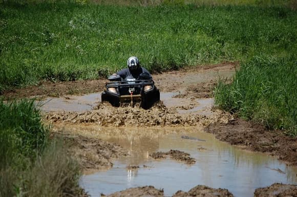 Going thru a deep rutted mud hole up to the tail lights. 

---Thats me!---