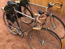chrome Schwinn Voyageur leaning on a mirror.