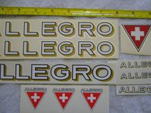 top row are two of Greg's horiz logotype plus the "clipped" Swiss Cross triangle, below the triangle are two of Greg's horiz chainstay logotypes
below Greg's are one each of my artwork Horiz for main tubes and chainstays, plus 3 of my triangles