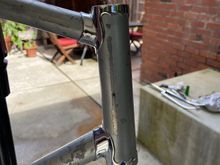 Had a riveted on head badge. The rivets are horizontal to each other and the badge was quite wide since the rivets are almost on the opposite side of each other. 
