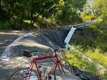 Further up the road, a fallen tree(background) adds another hazard.