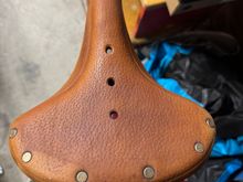 Bought a bike yesterday just for the saddle. Was stored outside and has dried out.  I tried some leather cleaner and a little naphtha to remove some old paint. But before I apply some proofide, is there anything better that might restore some luster?