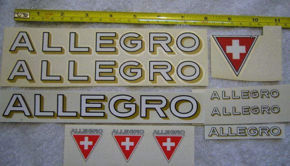 top row are two of Greg's horiz logotype plus the "clipped" Swiss Cross triangle, below the triangle are two of Greg's horiz chainstay logotypes
below Greg's are one each of my artwork Horiz for main tubes and chainstays, plus 3 of my triangles