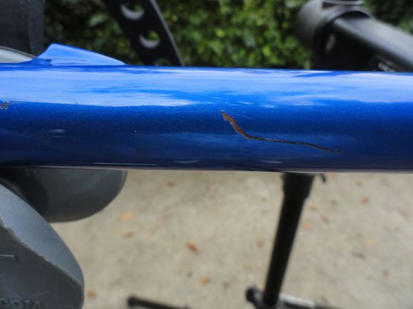 This scratch was hiding under a sticker about one inch long, and could be touched up easily.