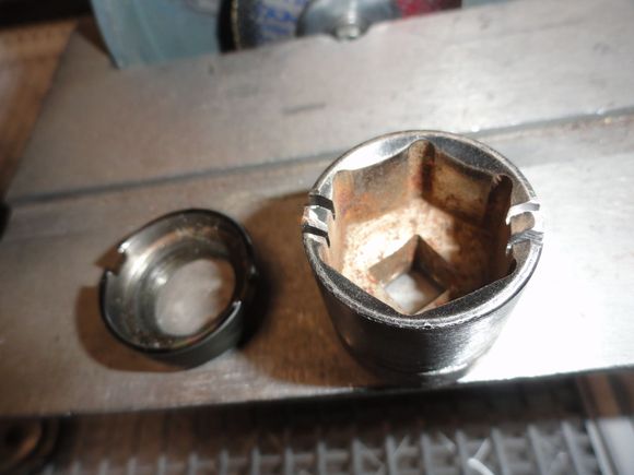A lock ring and the socket wit the two pins cut away on either side of the socket.