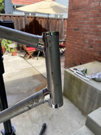 Had a riveted on head badge. The rivets are horizontal to each other and the badge was quite wide since the rivets are almost on the opposite side of each other. 