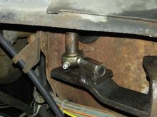 Ball joint threaded into coupler nut welded to a spacer to the Z arm. The rod above comrs thru the floor from the clutch pedal.