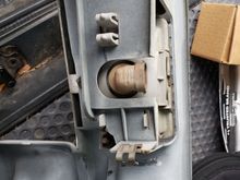 The plastic connector that behind the fog-light that holds the assembly to the grill. It is released by pinching the two together with your fingers.