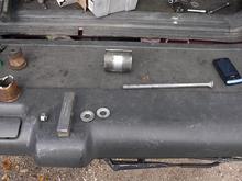 Here is my bushing puller setup. 1 galvanized 1/2" by 8" long hex bolt (Here I used a cap bolt but I should have gotten a hex bolt instead to put a wrench on the end for resistance) 2 washers, a 2" diameter by 3" long pipe cut and opened to 2 1/2" for the front bushing (the 2" will be sufficient for the rear bushing and the same for the upper bushings), I use the bar from a steering wheel puller as the brace and a 1/2" nut.