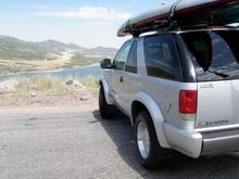 1996 2 door Blazer with 2 Kayaks on top and 2 mountain bikes inside.