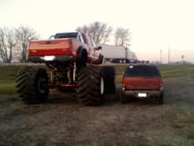 My Jimmy next to a lifted Stroker with 60x44's on it.  It makes my truck look like a toy with it's 32's.