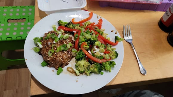 Turkey meatloaf with roasted broccoli and red peppers with green onion on top