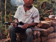 A young cousin. This boy is 8 - 10 years old. Works in the fields after a few hours of school.