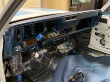 Dash in place. Glovebox door, lower ac ducts, gauges, radio and steering column next. 