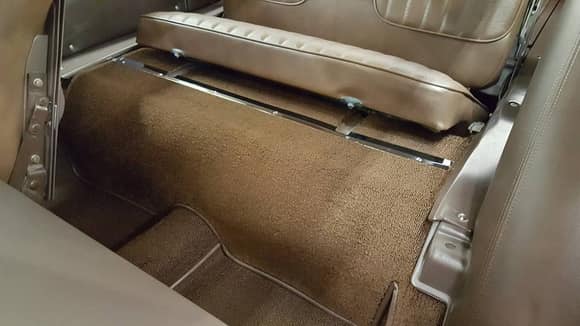 Upholsterer added carpet under 3rd seat.