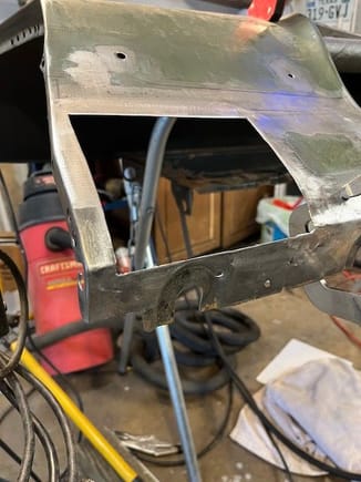 I cut out the rusty area preserving the perimeter and the lower flange that bolts to the bottom of the cowl.  The patch panel had a very narrow flange for the bottom cowl mount, so my idea was to retain the original metal.