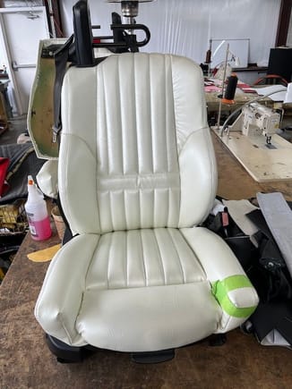 The side bolsters are too bulky and square.  The upholstery shop will take the bottom cover back apart and make it curve slightly to eliminate the hard corner.