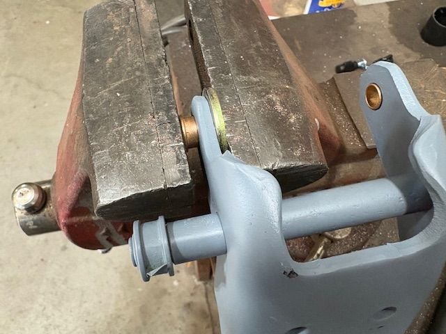The vice works great for this.  A backer washer provides room for the bushing to protrude through the hinge steel