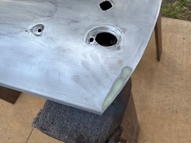 Since I am having back problems, I had my. Granddaughter h Eli Carr y the door out side a couple da us ago.  Y ou can see her  handprint in the corner.  A good example of what skin oils and salts will do to bare steel.  So it was sanded away .  Wiped down with grease and wax remover.  Tack clothed, and then t o coats of epoxy.