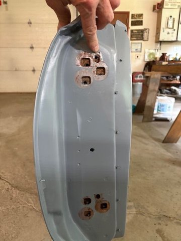 The door edge.  Notice one huge hole upper right.  Not sure what this hole is for, but think it may be a gauging or factory alignment hole used to attach doors as they go down the line.  Whatever.  I don’t want to put my single location hole in the door hinge leaf where that is.