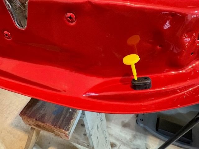 There are two small bumpers on latch end of door.  I happened to have a plastic push pin that made this task easy.  I am going to do the door seal with the door hanging.