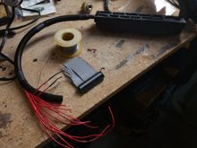 Once the wires were all soldered to the metra board, I ran them through some wire loom and soldered to the other half of the IDE extension cable through some super tiny heatshrink. I wish I'd put more of the large heatshrink on the loom before I started, since I'd much rather use that to bridge down to the smaller loom than the electrical tape. Either way, it worked out well.