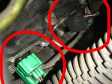 The green plug is plugged into camshaft sensor and the black plug is plugged into crankshaft sensors. It's he same on drivers side