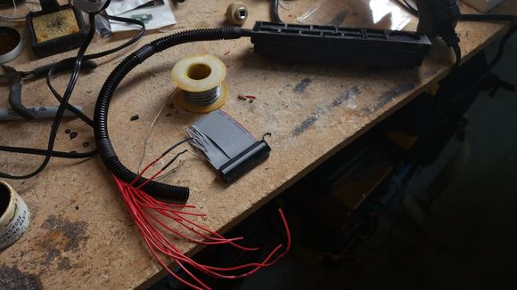 Once the wires were all soldered to the metra board, I ran them through some wire loom and soldered to the other half of the IDE extension cable through some super tiny heatshrink. I wish I'd put more of the large heatshrink on the loom before I started, since I'd much rather use that to bridge down to the smaller loom than the electrical tape. Either way, it worked out well.