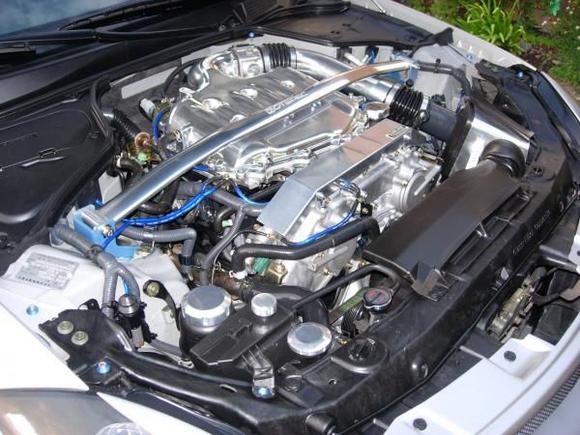 Newly installed SxExCx polished plenum, polished z-tube, polished GTSpec strut bar, and RareJDM harness cover.  Added some bling to the bay!  Only thing left are some blue venair hoses.