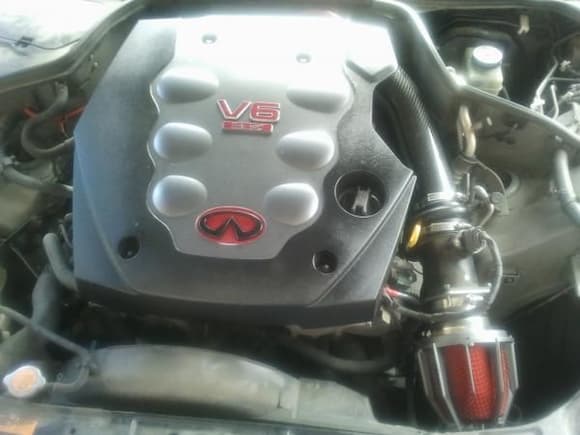 first thing I changed after painting the engine cover and taking care of the peeling chrome on my infiniti logo was to put a new air intake on it with a dragon filter by weapon r. the intake tube is from evo-r.net.