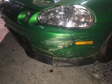 Big gash in bumper. Lots of grass and rocks.