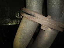 The leak is on the left hand side of the pic. This is looking at the front of the motor with my camera facing the motor just to be clear. You can see a little black soot on the exhaust from the leak. It makes a super annoying ticking sound all the time, and there is black soot on my radiator.