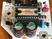 Capacitors - round, brown components w/ green stripes.
