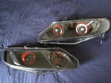 06-11 civic sedan

quad morimoto mini h1 projectors
quad type k shrouds
reflectors, back of shrouds, turn signals painted black
front of Shroud painted red