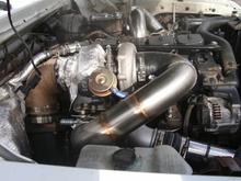 Compound turbo setup.   It's a 57/65/14 S300 over a modified HT3B.   Good for 650 whp, if you have the fuel.   For my truck... 400-450 whp.