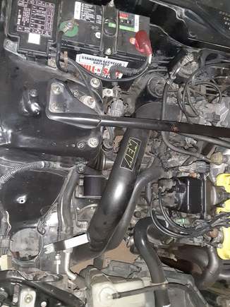 This one shows me how it clears AC lines, and also makes it clear it reaches under the frame rail into the air space, it doesn't go in from the top where the factory air box does.