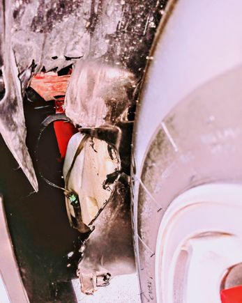 The damage done to the driver's inner fender.