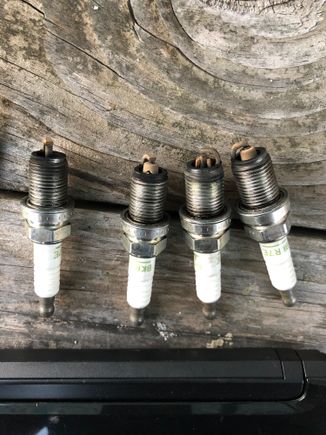 1-3 plug are missing and cracked insulator except number 4.... 

Can someone help and explain why and how this happened??? Too much heat...