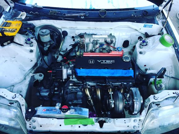 Well this happened this past weekend! Took the time to just hang the motor for now just so I could get it over to kellybuilt for all the fab work. Was surprised at how well the manifold and turbo fit. Only had to cut the hood in one spot to clear the turbo. The only downfall was the wastegate sits very close to the radiator so we will see how that goes once it's all running