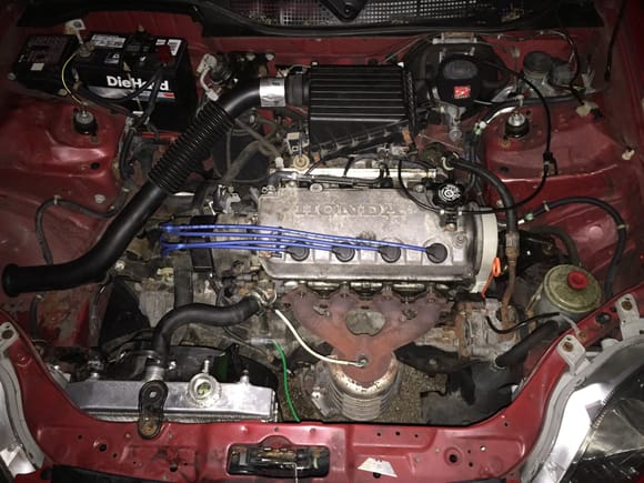Heres the car about 9 at night all finished with the manifold just sitting on so it doesnt throw a code, also got the new Mishimoto Rad on the car as well had trouble making the coolant hoses fit Maybe I need New Ones????