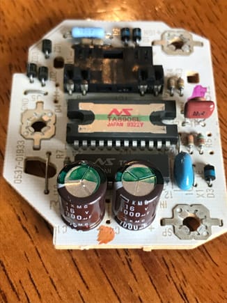 Capacitors - round, brown components w/ green stripes.