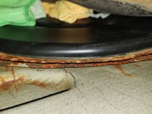 Rust around round black access panel. Also not sure if I should be worried about the cracked sound dampening sheet... rust under it could be a problem. 