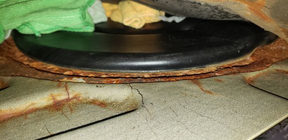 Rust around round black access panel. Also not sure if I should be worried about the cracked sound dampening sheet... rust under it could be a problem. 